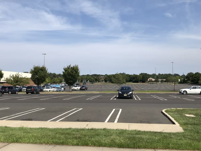 A vast, mostly empty parking lot.