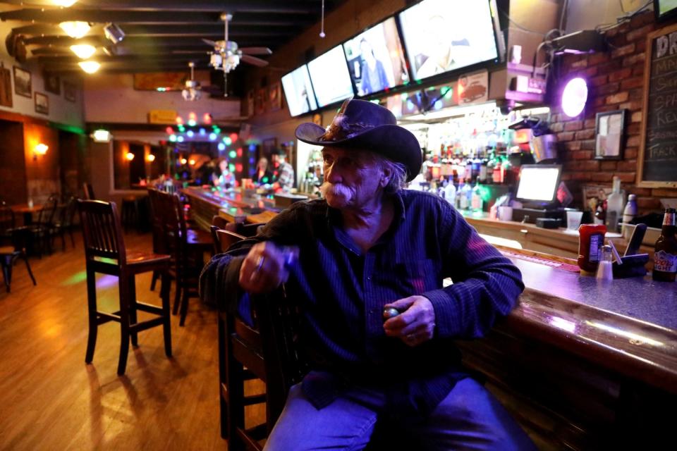 A man in a cowboy hat at the bar in the Palomino Room