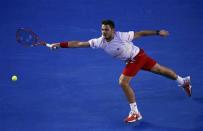 Stanislas Wawrinka of Switzerland hits a return to Tomas Berdych of the Czech Republic during their men's singles semi-final match at the Australian Open 2014 tennis tournament in Melbourne January 23, 2014. REUTERS/David Gray