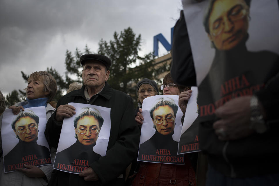 People rally, holding portraits of slain journalist Anna Politkovskaya, in downtown Moscow, Sunday, Oct. 7, 2012. About 200 people rallied Thursday on the 6th anniversary of the killing of Anna Politkovskaya, calling on the authorities to find and punish the killers of journalists and human rights activists in Russia. (AP Photo/Alexander Zemlianichenko)