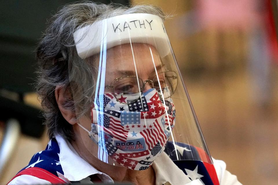 In Texas, Harris County election clerk Kathy Kellen wears a mask and face shield while working at a polling site on June 29, 2020, in Houston.