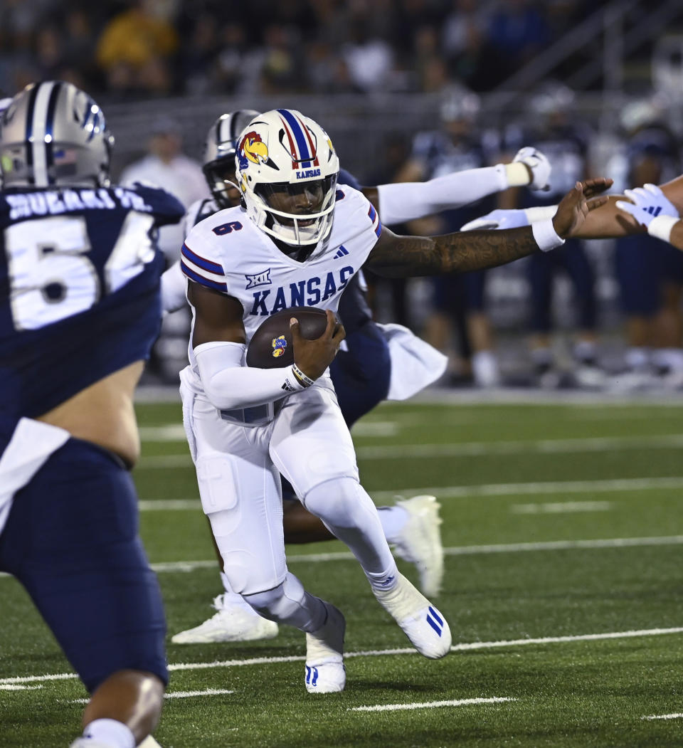 Kansas quarterback runs with the ball against Nevada during the first half of an NCAA college football game Saturday, Sept. 16, 2023 in Reno Nev. (AP Photo/Andy Barron)