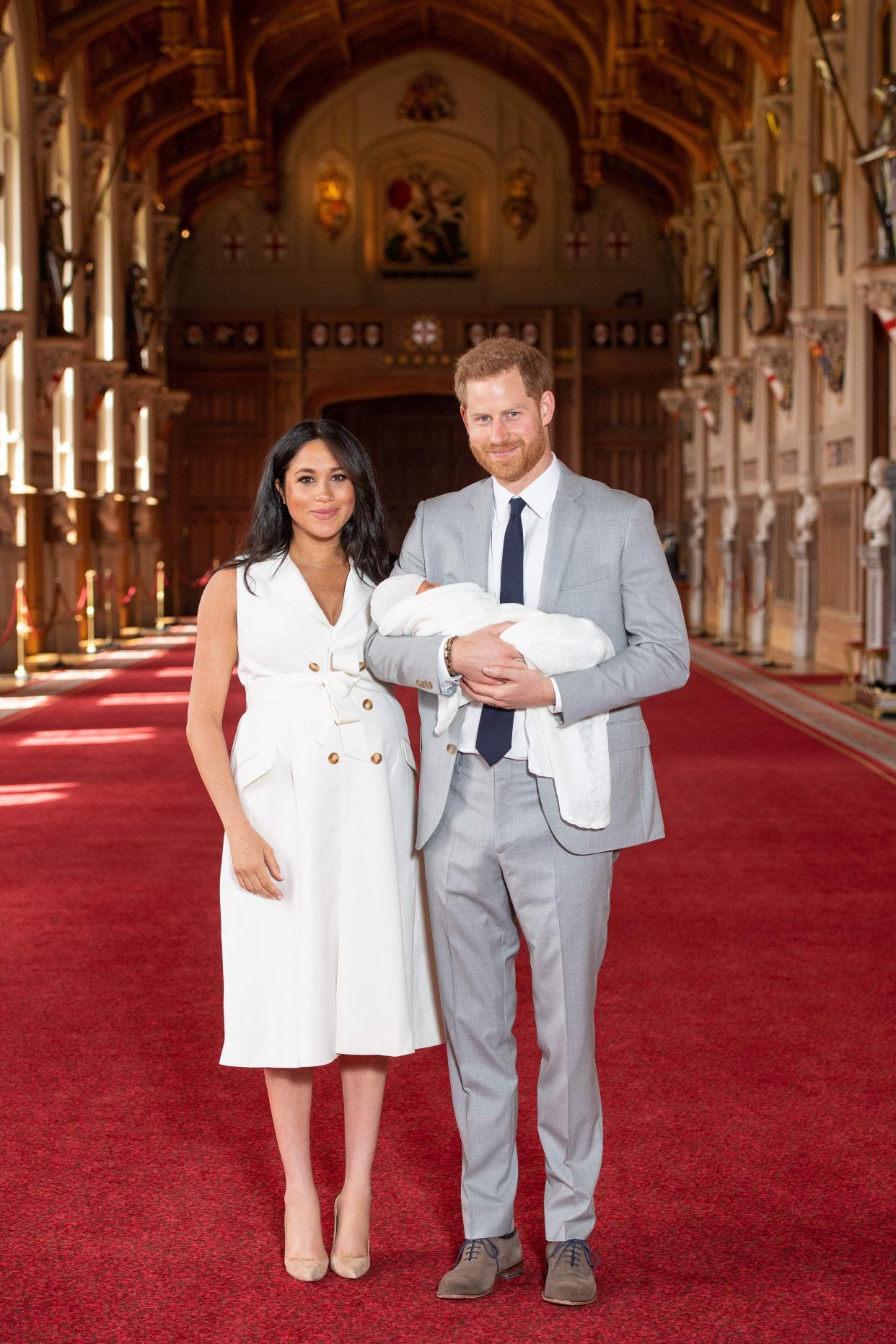 Britain's Prince Harry, Duke of Sussex (R), and his wife Meghan, Duchess of Sussex, pose for a photo with their newborn baby son in St George's Hall at Windsor Castle in Windsor, west of London on May 8, 2019. (Photo by Dominic Lipinski / POOL / AFP)        (Photo credit should read DOMINIC LIPINSKI/AFP/Getty Images)