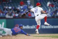 Mar 31, 2019; Arlington, TX, USA; Texas Rangers second baseman Rougned Odor (12) turns a double play in the ninth inning against Chicago Cubs catcher Willson Contreras (40) at Globe Life Park in Arlington. Mandatory Credit: Tim Heitman-USA TODAY Sports