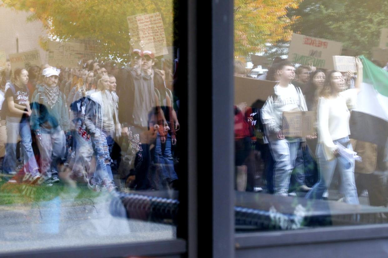 Students at UMass Amherst march across campus following a walkout and rally protesting the university's "ties with war profiteers," while also calling for "a ceasefire and end of the blockade on Gaza." <a href="https://www.gettyimages.com/detail/news-photo/amherst-ma-a-student-in-a-classroom-watches-as-umass-news-photo/1745625977?adppopup=true" rel="nofollow noopener" target="_blank" data-ylk="slk:Jessica Rinaldi/The Boston Globe via Getty Images;elm:context_link;itc:0;sec:content-canvas" class="link ">Jessica Rinaldi/The Boston Globe via Getty Images</a>