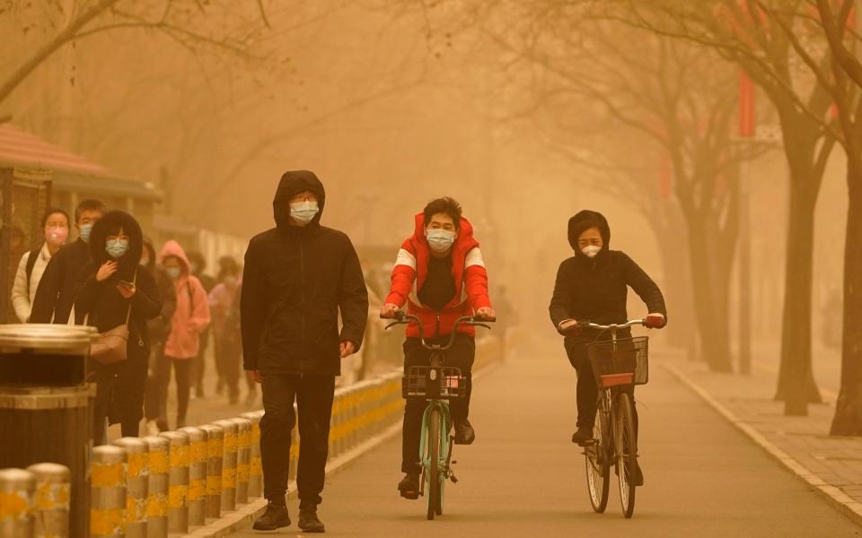 The sandstorm brought a tinted haze to Beijing's skies and sent air quality indices soaring  - Ng Han Guan /AP