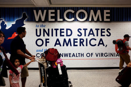 A family exits after clearing immigration and customs at Dulles International Airport in Dulles, Virginia, U.S. September 24, 2017. REUTERS/James Lawler Duggan
