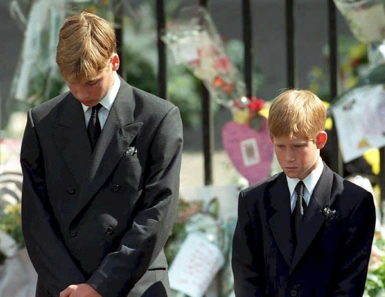 Prince William (left) and Prince Harry bow their heads during the funeral of their mother Diana, Princess of Wales, at Westminster Abbey in 1997