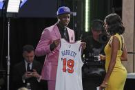 Duke's RJ Barrett shows off a jersey after being selected as the third pick overall by the New York Knicks during the NBA basketball draft Thursday, June 20, 2019, in New York. (AP Photo/Julio Cortez)