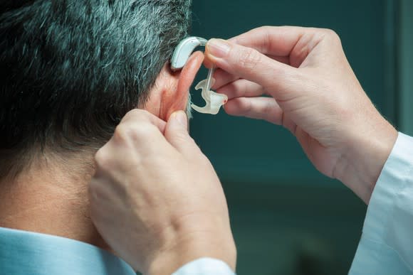 Man getting fitted for hearing aid