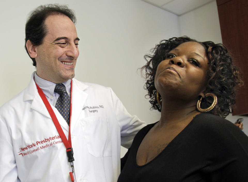 In this March 23, 2012 photo, Dr. Francesco Rubino, a surgeon at Weill Cornell Medical Center, joins his patient Tamikka McCray, 39, for an interview in New York. McCray no longer needed to take diabetes medication and insulin after her weigh-loss surgery. Research by Dr. Francesco Rubino, McCray's surgeon at Weill Cornell, and other doctors gives clear proof that weight-loss surgery can reverse and possibly cure diabetes. (AP Photo/Bebeto Matthews)