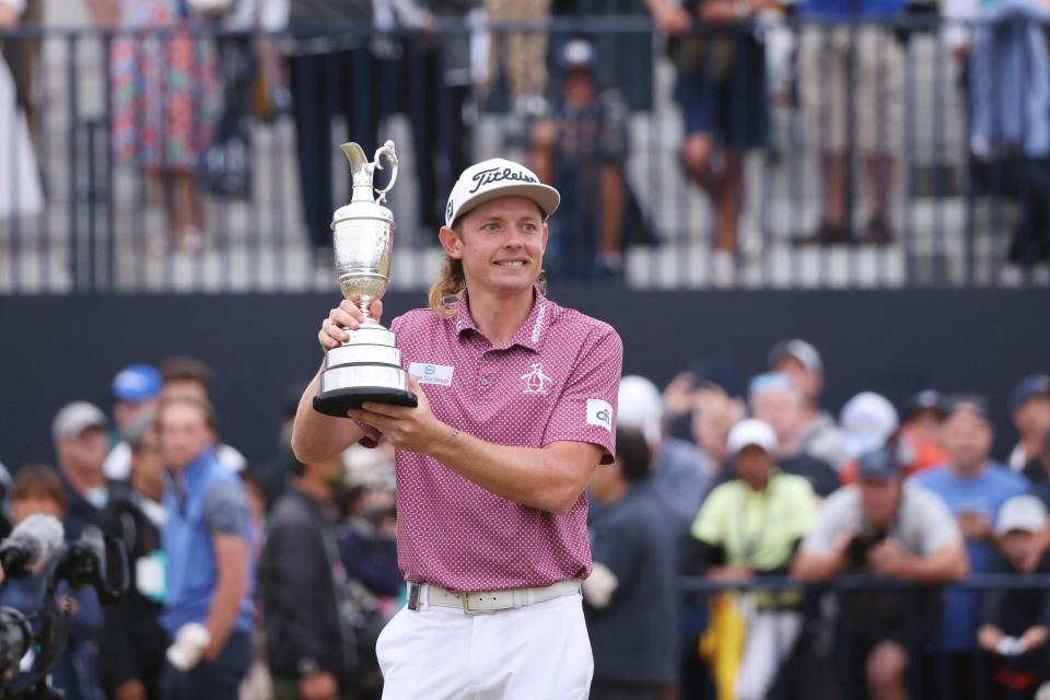 Cameron Smith, of Australia, holds the claret jug trophy as he poses for photographers on the 18th green after winning the British Open golf Championship on the Old Course at St. Andrews, Scotland, Sunday July 17, 2022. (AP Photo/Peter Morrison)