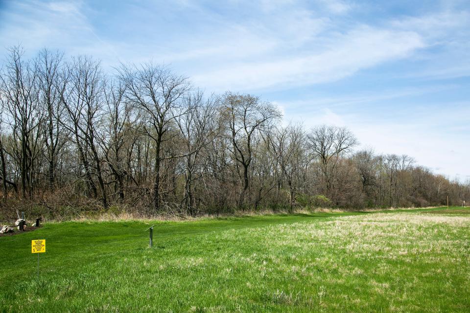 A sign marks where a prairie restoration is in progress, Wednesday, May 4, 2022, at the University of Iowa Ashton Cross Country Course in Iowa City, Iowa.