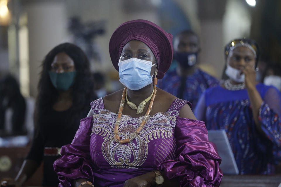 A parishioner wearing face mask to protect against coronavirus, attend a morning Christmas Mass at Holy Cross Cathedral in Lagos, Nigeria, Friday Dec. 25, 2020. Africa's top public health official says another new variant of the coronavirus appears to have emerged in Nigeria, but further investigation is needed. The discovery could add to new alarm in the pandemic after similar variants were announced in recent days in Britain and South Africa and sparked the swift return of travel restrictions. (AP Photo/Sunday Alamba)