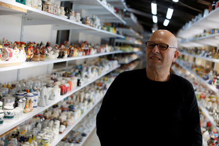 Eitan Bar-on stands next his collection of 37,000 pairs of shakers, displayed in a shack at the backyard of his home in Hadera, Israel December 12, 2018. Picture taken December 12, 2018. REUTERS/Nir Elias