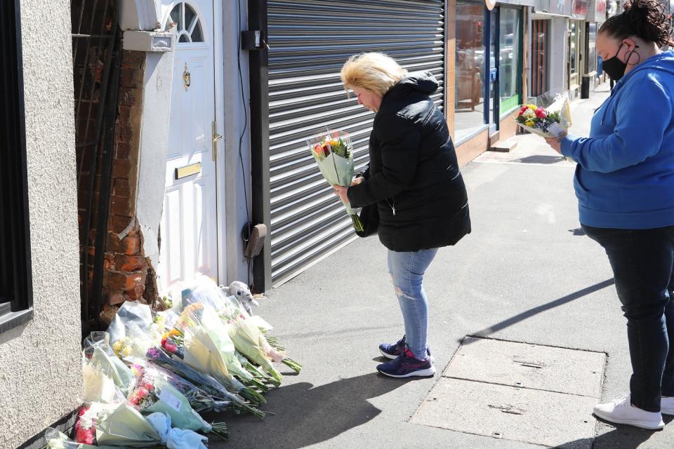 Family members laying flowers (SWNS)