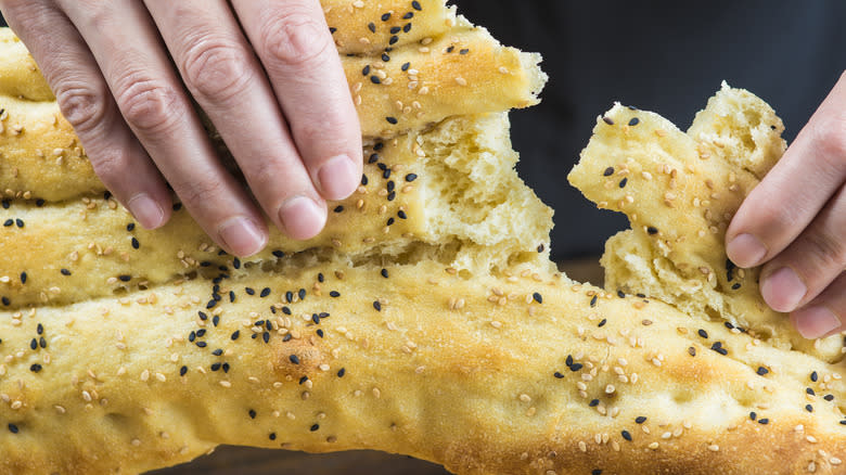 Hands tearing Persian bread