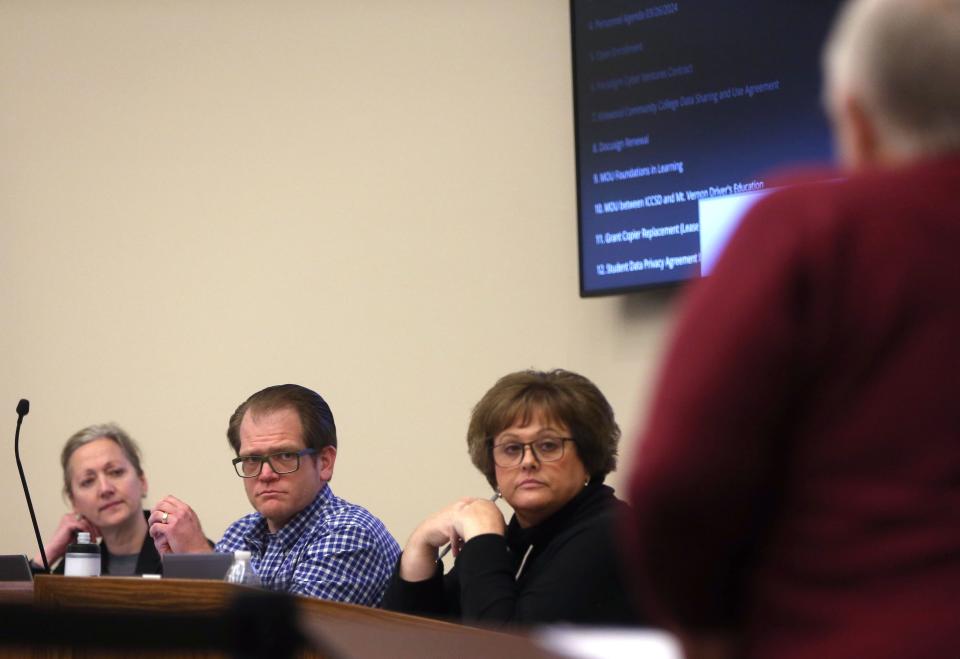 Iowa City Community School District director Mitch Lingo, left, listens to residents during a public comment section as a proposal to close Hills Elementary School following the 2023-24 school year is discussed Tuesday, March 26, 2024 in Iowa City.