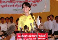 FILE - Burmese pro-democracy leader Aung San Suu Kyi shares a lighter moment with journalists at the conclusion of the NLD (National League for Democracy) party conference in Rangoon on May 28, 1996. Suu Kyi is the daughter of the country’s independence hero, Gen. Aung San, who was assassinated in 1947, less than six months before the country, then called Burma, became independent from Britain. Suu Kyi moved to New Delhi in 1960 when her mother was appointed ambassador to India and then spent most of her young adult life in the United States and England. Her career in politics began in 1988. (AP Photo/Richard Vogel, File)