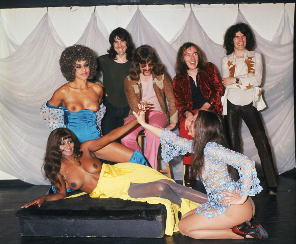 Scottish rock group Nazareth with a trio of scantily-clad ladies, 27th October 1971. Left to right: Manny Charlton, Darrell Sweet (1947 - 1999), Pete Agnew and Dan McCafferty.