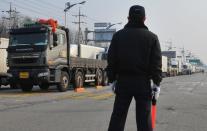 Trucks arriving from South Korea wait at a military checkpoint near the border with North Korea in Paju on April 4, 2013. North Korea blocked access to its joint industrial zone with South Korea for a second consecutive day on Thursday, an AFP journalist near Paju said