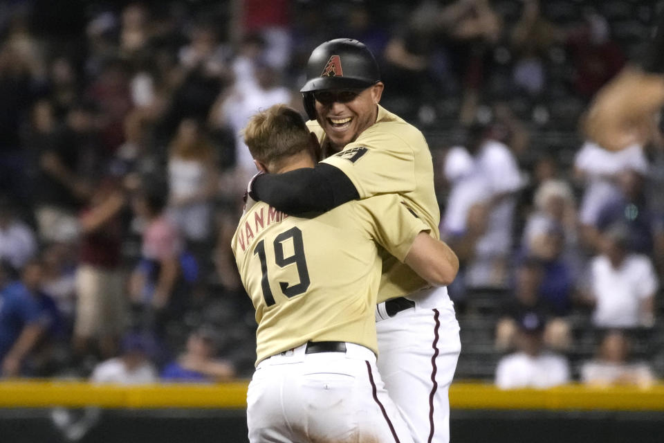 Arizona Diamondbacks' Asdrubal Cabrera celebrates with Josh VanMeter (19) after hitting a walk off RBI single against the Los Angeles Dodgers during a baseball game, Friday, July 30, 2021, in Phoenix. Arizona won 6-5. (AP Photo/Rick Scuteri)