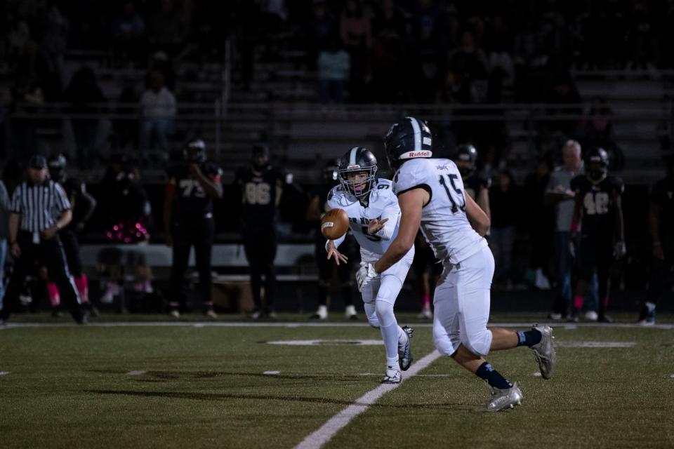 CR North sophomore Julian Matera passes the ball to senior Gavin Papp at Harry S. Truman High School in Levittown on Friday, Oct. 7, 2022. The Tigers fell to the Indians 13-20.
