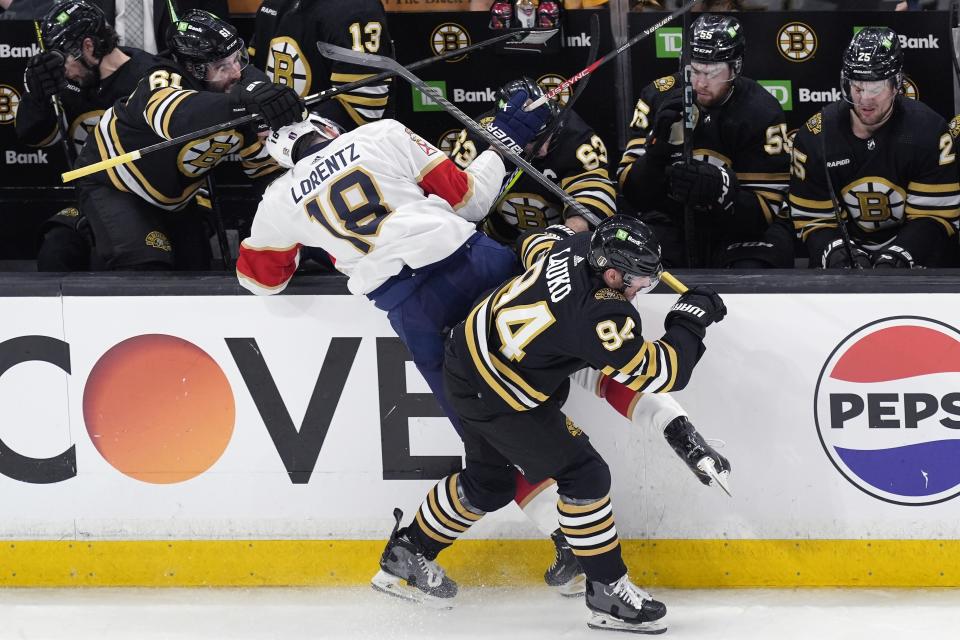 Boston Bruins' Jakub Lauko (94) checks Florida Panthers' Steven Lorentz (18) during the second period in Game 3 of an NHL hockey Stanley Cup second-round playoff series Friday, May 10, 2024, in Boston. (AP Photo/Michael Dwyer)