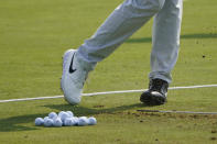 Cameron Champ, wearing two different shoes Wednesday, Aug. 26, 2020, displays the message "Jacob Blake BLM" during a practice round for the BMW Championship golf tournament at the Olympia Fields Country Club in Olympia Fields, Ill. (AP Photo/Charles Rex Arbogast)