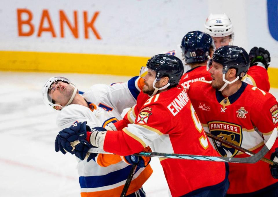 New York Islanders right wing Cal Clutterbuck (15) gets punched in a scuffle with Florida Panthers defensemen Oliver Ekman-Larsson (91) and Dmitry Kulikov (7) during the third period of a game on Thursday, March 28, 2024, at Amerant Bank Arena in Sunrise, Fla. The New York Islanders won 3-2. Alie Skowronski/askowronski@miamiherald.com