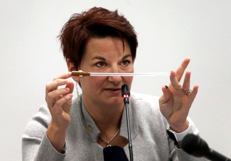 Dr.Colleen McNicholas, chief medical officer at Planned Parenthood, holds a plastic cannula, a piece of equipment Planned Parenthood uses during abortion procedures, as she answers questions by Planned Parenthood attorney Richard Muniz on the third day of hearings between Planned Parenthood and Missouri Department of Health and Senior Services on whether Planned Parenthood can keep its abortion license on Wednesday, Oct. 30, 2019, in St. Louis. (Laurie Skrivan/St. Louis Post-Dispatch via AP)