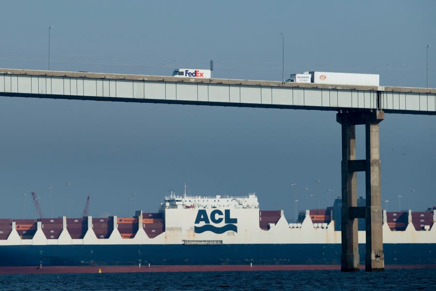A Federal Express and a Frito-Lay truck cross the Francis Scott Key Bridge and pass over an Atlantic Container Line cargo ship in Baltimore, Maryland, on October 14, 2021.(Photo by BRENDAN SMIALOWSKI/AFP via Getty Images)