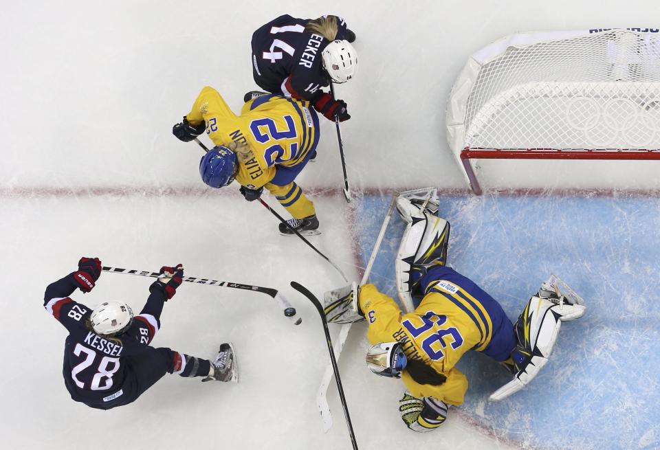 Team USA's Amanda Kessel (L) shoots past Sweden's goalie Valentina Wallner (35) to score during the first period of their women's semi-final ice hockey game at the Sochi 2014 Winter Olympic Games, February 17, 2014. REUTERS/Laszlo Balogh (RUSSIA - Tags: OLYMPICS SPORT ICE HOCKEY TPX IMAGES OF THE DAY)