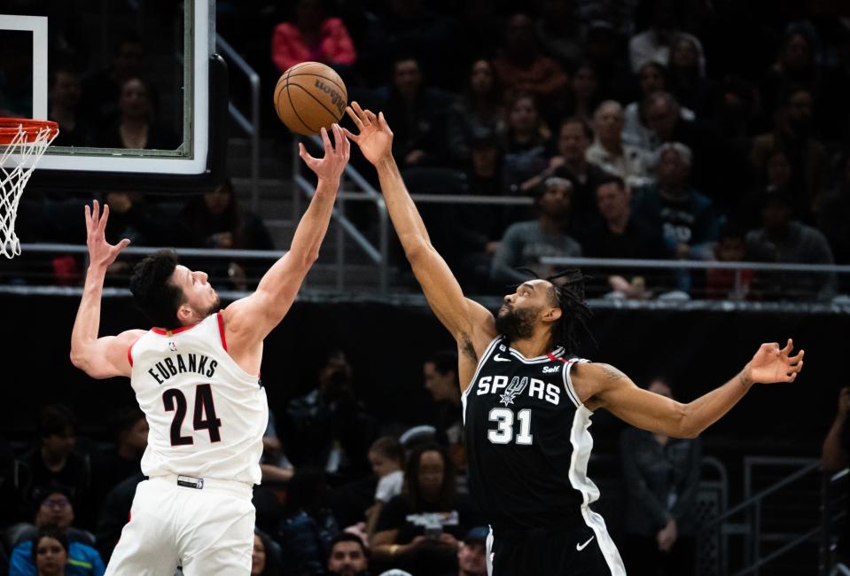 San Antonio Spurs forward Keita Bates-Diop (31) and Portland Trail Blazers forward Drew Eubanks (24) both reach for the rebound during the second half of the Spurs' 129-127 victory over the Trail Blazers at the Moody Center in Austin, Thursday, April 6, 2023. The Spurs will play another game in Austin on Saturday as part of the Interstate 35 Series.