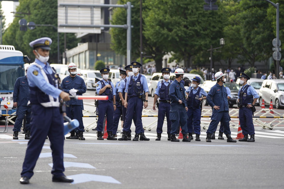 Police block the road leading to Nippon Budokan where the controversial state-sponsored funeral of former Prime Minister Shinzo Abe, Tuesday, Sept. 27, 2022, in Tokyo. Abe was assassinated in July. (AP Photo/Christopher Jue)