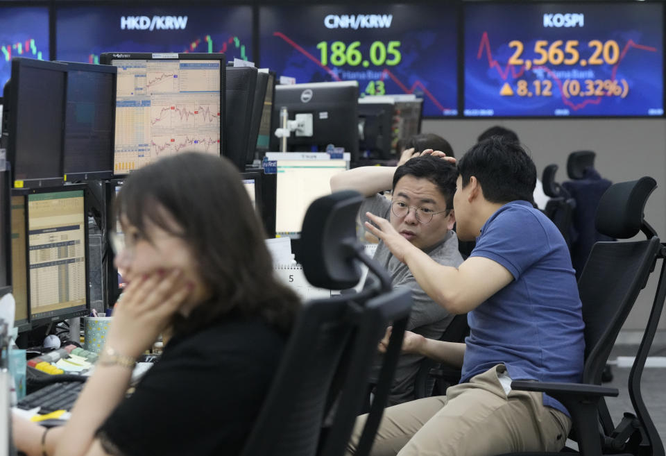 Currency traders work at the foreign exchange dealing room of the KEB Hana Bank headquarters in Seoul, South Korea, Tuesday, May 23, 2023. Asian stock markets were mixed Tuesday after more talks in Washington on government debt ended with no deal to avoid a potentially jarring default.(AP Photo/Ahn Young-joon)