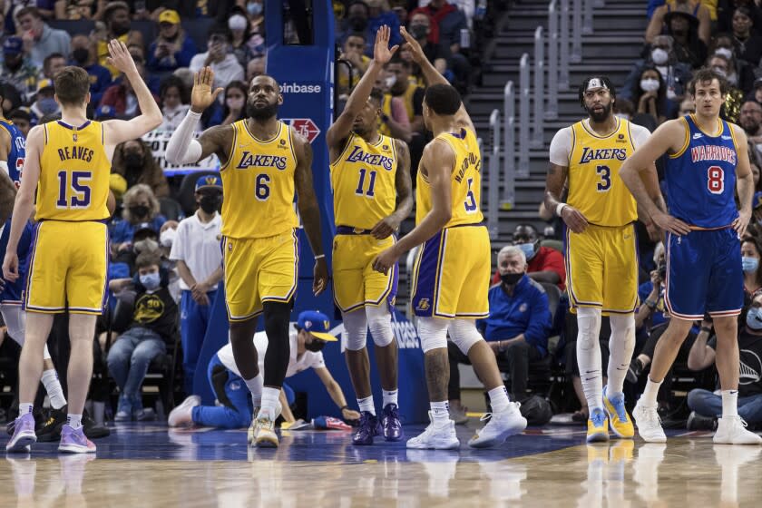 Los Angeles Lakers guard Austin Reaves (15), forward LeBron James (6), guard Talen Horton-Tucker (5). guard Malik Monk (11) and other players celebrate a foul called against the Golden State Warriors during the second half of an NBA basketball game in San Francisco, Saturday, Feb. 12, 2022. The Warriors won 117-115. (AP Photo/John Hefti)