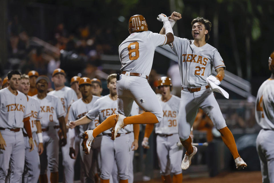 Texas' Dylan Campbell (8) and Jack O'Dowd (27) celebrate Campbell's home run against Miami during the first inning of an NCAA college baseball tournament regional game in Coral Gables, Fla., Saturday, June 3, 2023. (Al Diaz/Miami Herald via AP)