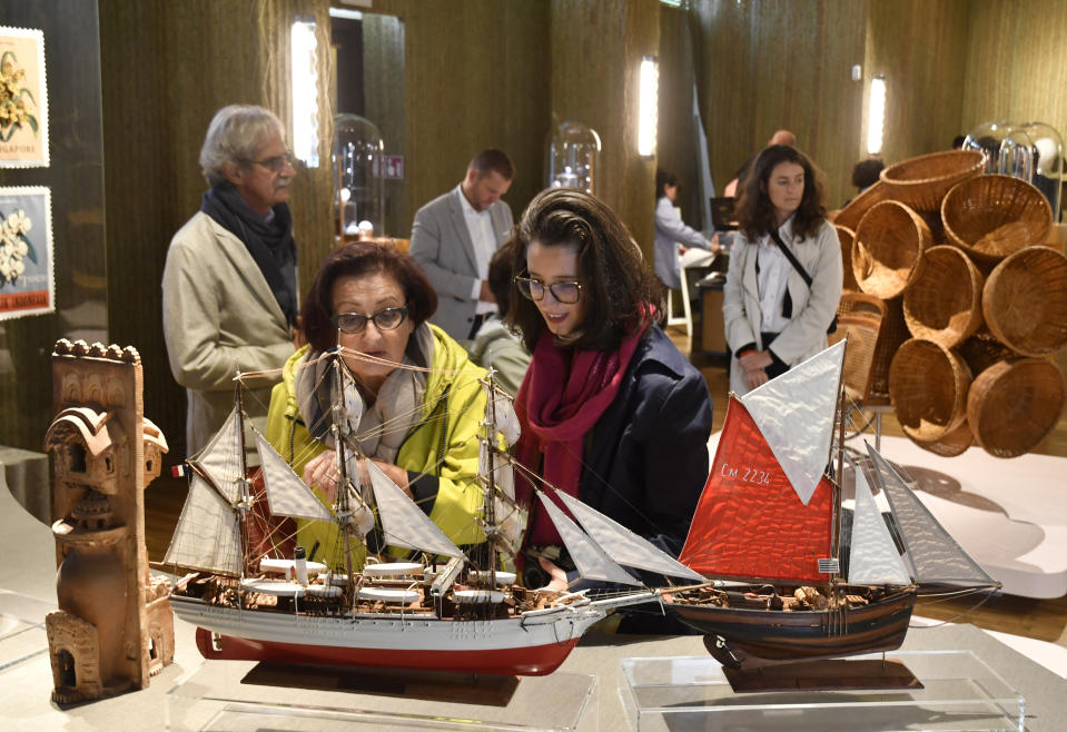 Visitors attend an exhibition of model ships made by the Madagascar company Le Village and on display at the Homo Faber 2024 show in Venice, Italy, Friday, Sept. 13, 2024.(AP Photo/Luigi Costantini)