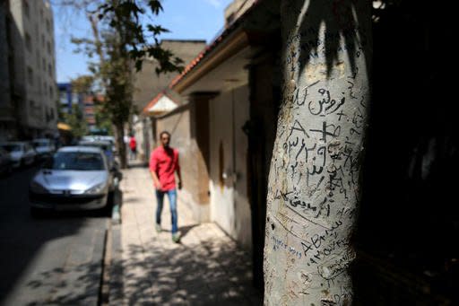 This Tuesday, Aug. 2, 2016 photo, shows handwritten advertisements for human kidneys for sale that includes the sellers' phone number and blood type, on a tree in downtown Tehran, Iran. A unique system allows those in need of a transplant to buy a kidney. The program, which has seen Iran’s waitlist for kidneys effectively drop to zero, has been championed by some Western doctors as a way to cut time for lifesaving transplants. However, some ethicists worry about the system taking advantage of the poor worldwide to black-market organ sales. (AP Photo/Ebrahim Noroozi)