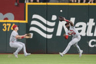 St. Louis Cardinals right fielder Jordan Walker (18) catches the fly-out in front of center fielder Tommy Edman (19) that was hit by Texas Rangers' Robbie Grossman during the second inning of a baseball game, Wednesday, June 7, 2023, in Arlington, Texas. (AP Photo/Jim Cowsert)