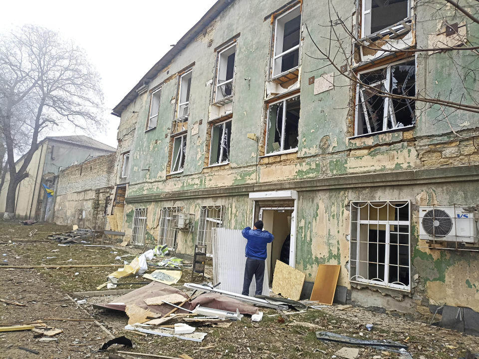 A man stands next to a building damaged after a Russian attack in Odesa, Ukraine, Friday, Dec. 29, 2023. (AP Photo/Artem Perfilov)