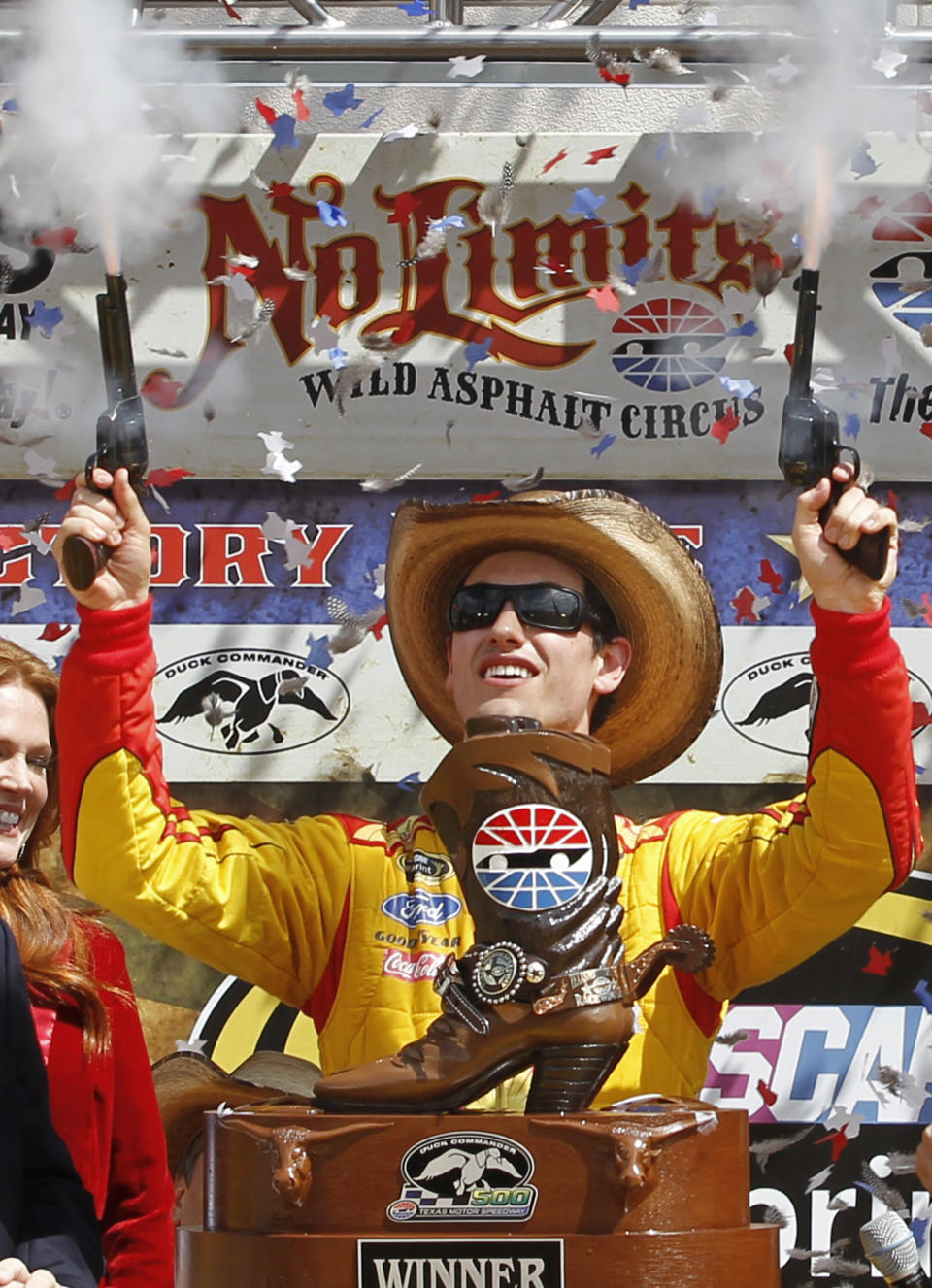 Joey Logano shoots off pistols celebrating winning the NASCAR Sprint Cup Series auto race at Texas Motor Speedway Monday, April 7, 2014, in Fort Worth, Texas. (AP Photo/Mike Stone)
