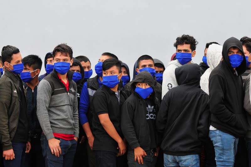 Guatemalan unaccompanied minors walk on the tarmac after arriving on a deportation flight from Mexico, at the Guatemalan Air Force (FAG) headquarters in La Aurora International Airport, in Guatemala City