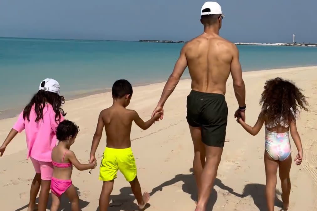 <p>Cristiano Ronaldo</p> Cristiano Ronaldo and his kids talk a walk on the beach