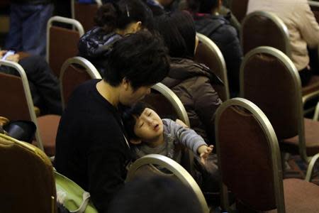 A young relative of a passenger aboard Malaysia Airlines flight MH370 reacts during a meeting with Malaysia Airlines at Lido Hotel in Beijing, March 16, 2014. REUTERS/Jason Lee