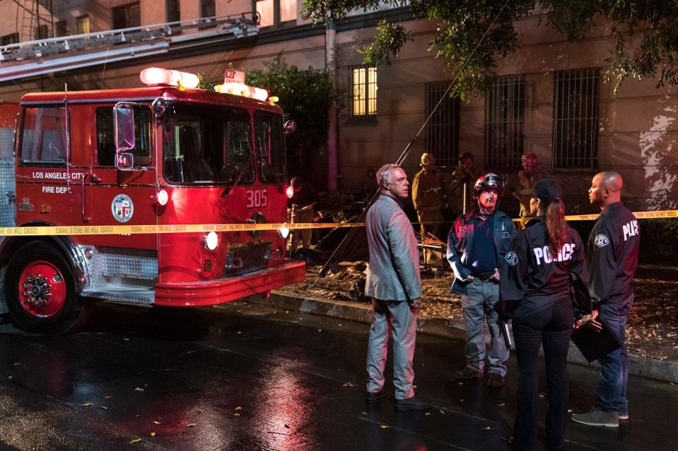 Los Angeles detective Harry Bosch (Titus Welliver), in gray suit, arrives at the scene of an arson in the final season of Amazon's "Bosch."