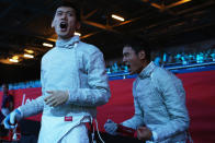 LONDON, ENGLAND - AUGUST 03: Bongil Gu and Junghwan Kim of Korea celebrate beating Italy during the Men's Sabre Team Fencing semifinal on Day 7 of the London 2012 Olympic Games at ExCeL on August 3, 2012 in London, England. (Photo by Hannah Johnston/Getty Images)