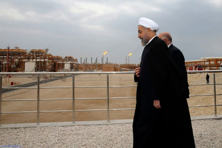 Iranian President Hassan Rouhani (L) walking with Oil Minister Bijan Namdar Zanaganeh (R) at phase 12 of the South Pars gas field facilities in the southern Iranian port of Assaluyeh last year