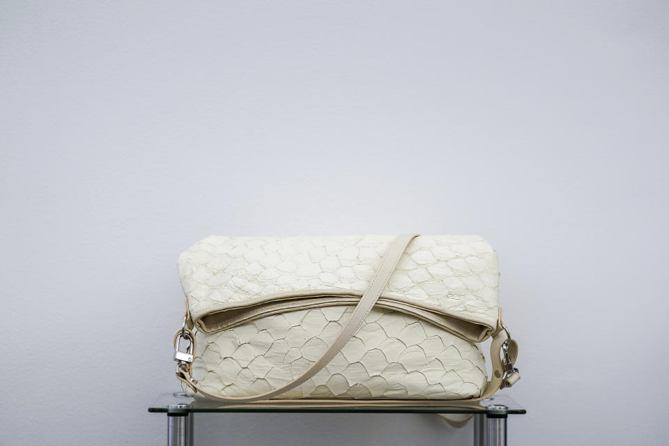 The clay white Playa Shoulder Bag, made out of pirarucu leather, is displayed in Piper & Skye's showroom, Tuesday, Oct. 25, 2022, in New York. In New York City, the luxury brand Piper & Skye has used pirarucu leather for shoulder bags, waist packs and purses that can fetch up to $850. (AP Photo/Julia Nikhinson)